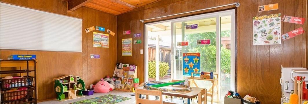 The Little Learners classroom, with bilingual posters and a door to the yard